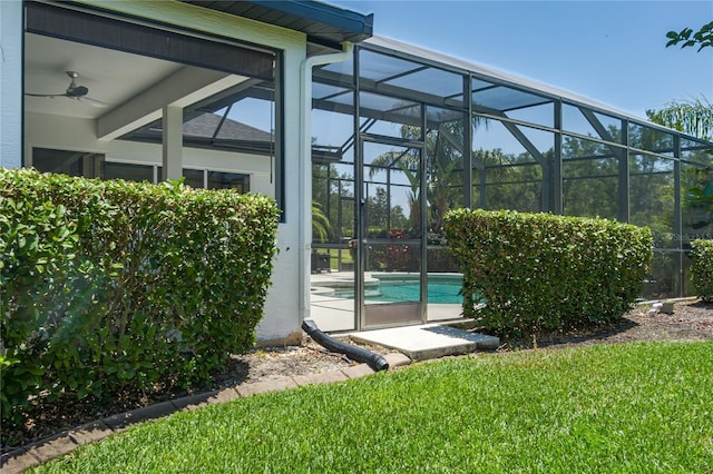 3806 155th Ave E, Parrish, FL 34219 - view of side of property with an outdoor pool, a lanai, a lawn, and a ceiling fan