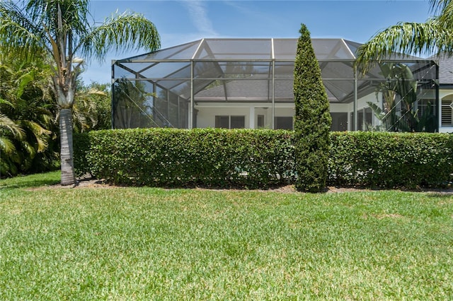 3806 155th Ave E, Parrish, FL 34219 - back of house with a lawn and glass enclosure