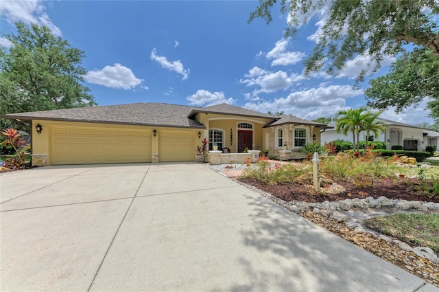 view of front facade featuring an attached garage, driveway, and stucco siding