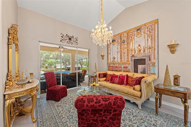 living area with baseboards, wood finished floors, a chandelier, and high vaulted ceiling