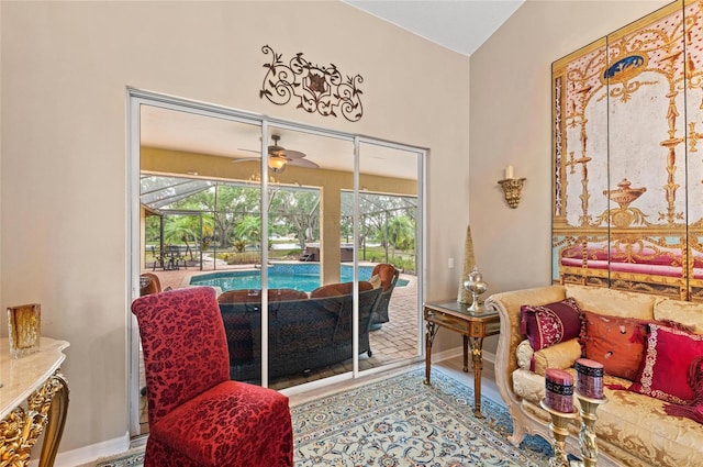sitting room featuring plenty of natural light, baseboards, and a sunroom