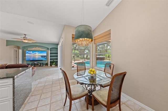 dining area featuring visible vents, baseboards, ceiling fan with notable chandelier, and vaulted ceiling