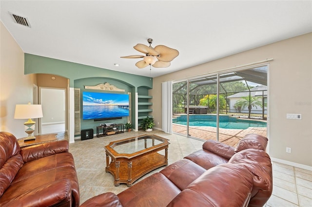 living area with ceiling fan, tile patterned floors, a sunroom, baseboards, and visible vents