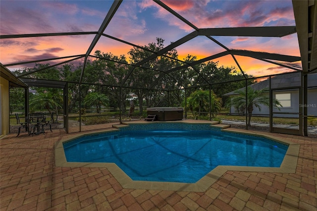outdoor pool featuring a patio, a hot tub, and glass enclosure