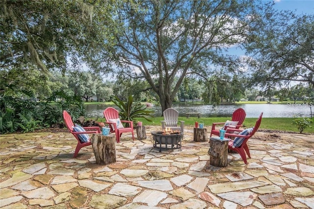 view of patio / terrace with a water view and a fire pit