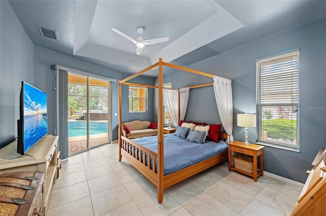 bedroom featuring visible vents, light tile patterned flooring, access to exterior, baseboards, and a textured ceiling