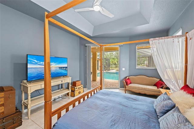 bedroom featuring ceiling fan, a tray ceiling, and access to exterior