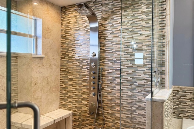 full bath with tile walls and a shower stall