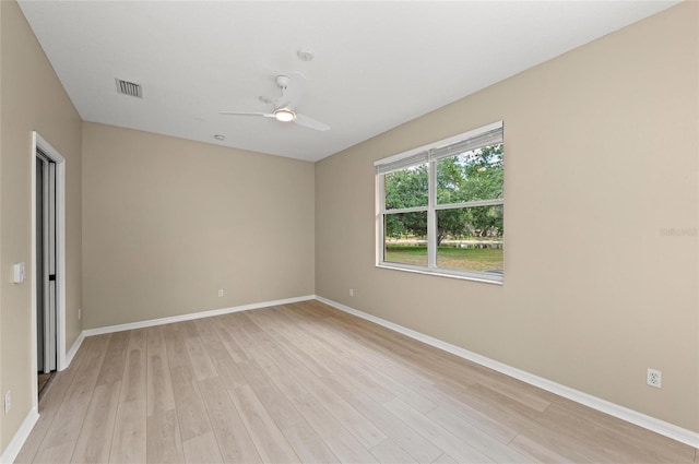 unfurnished room with ceiling fan, baseboards, and light wood-type flooring