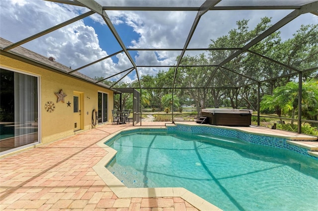 outdoor pool featuring a lanai, a hot tub, and a patio area