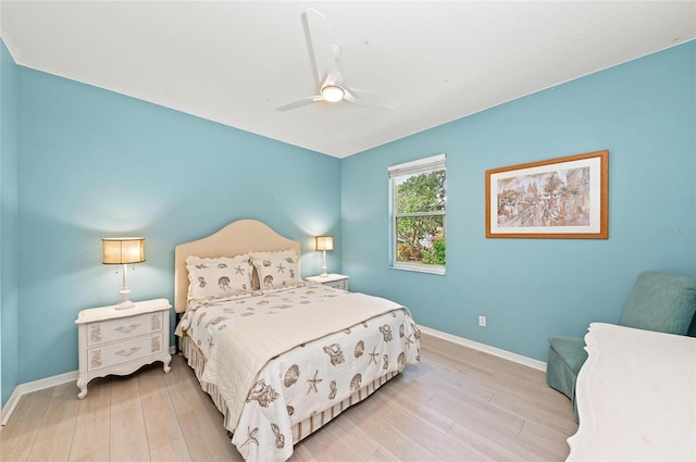 bedroom featuring baseboards, light wood-style floors, and ceiling fan