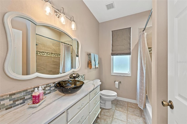 bathroom featuring vanity, toilet, baseboards, decorative backsplash, and visible vents