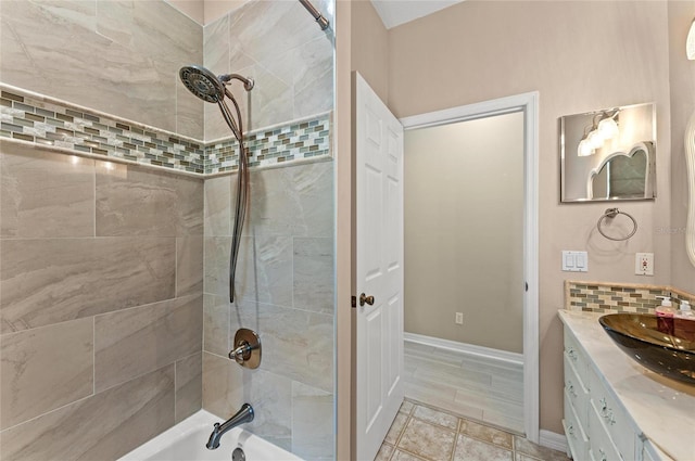 full bath featuring vanity, baseboards, backsplash, and  shower combination