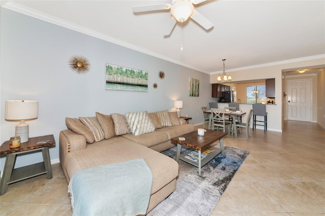 living area featuring ornamental molding, ceiling fan with notable chandelier, light tile patterned floors, and baseboards