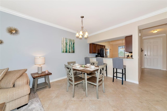 dining space featuring light tile patterned floors, a chandelier, ornamental molding, and baseboards