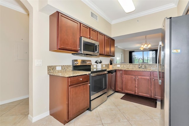 kitchen featuring a chandelier, light tile patterned floors, crown molding, light stone counters, and appliances with stainless steel finishes