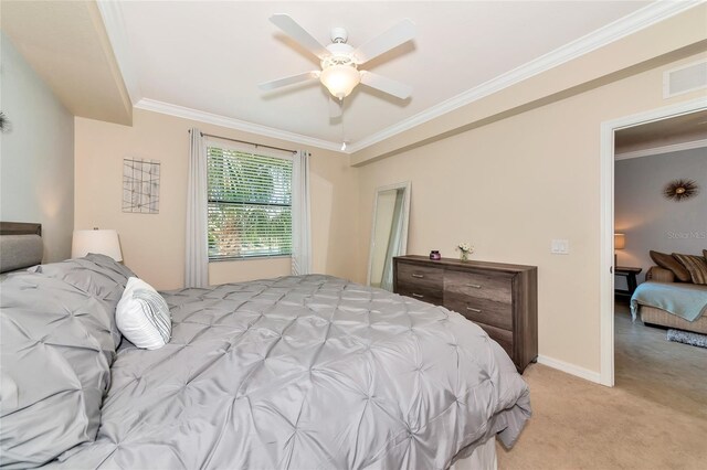 bedroom featuring baseboards, visible vents, ornamental molding, and light carpet