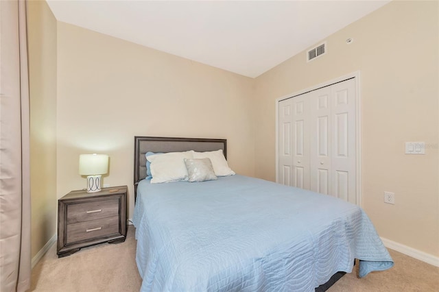 bedroom with visible vents, a closet, baseboards, and carpet floors