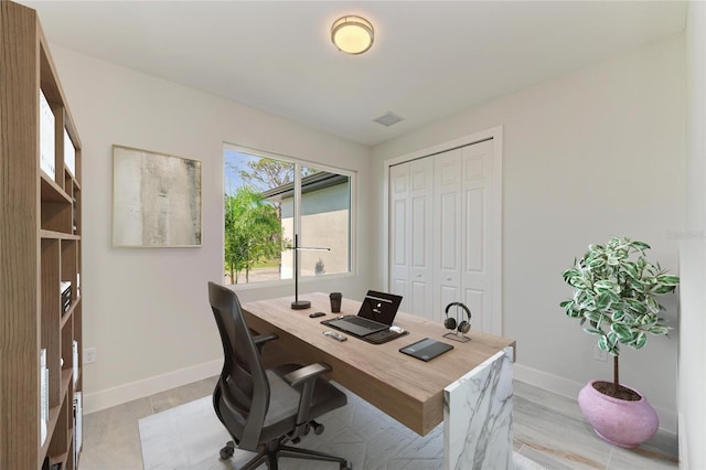 office featuring visible vents and baseboards