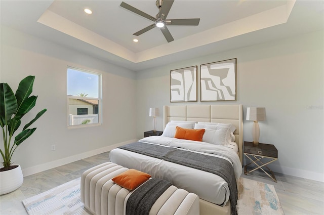 bedroom featuring baseboards, recessed lighting, a raised ceiling, and ceiling fan