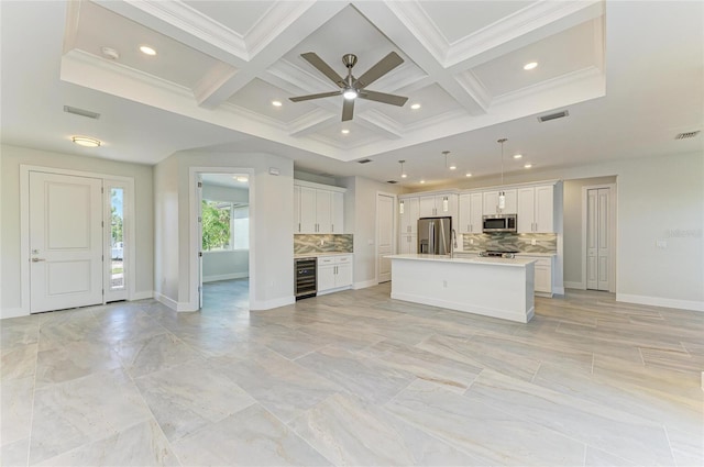 unfurnished living room with visible vents, ceiling fan, coffered ceiling, and wine cooler