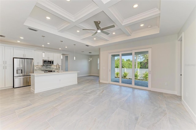 unfurnished living room with coffered ceiling, a ceiling fan, visible vents, and baseboards