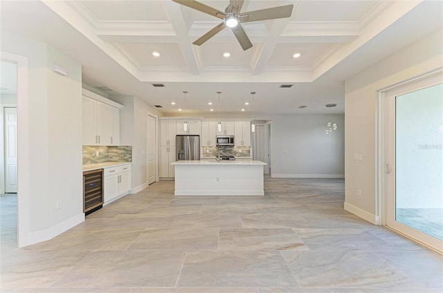 kitchen with recessed lighting, tasteful backsplash, appliances with stainless steel finishes, and beverage cooler