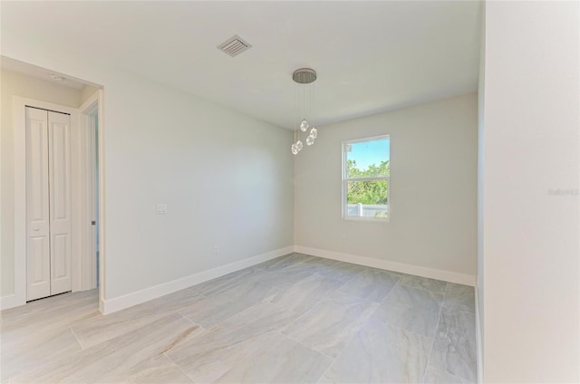 empty room featuring visible vents and baseboards