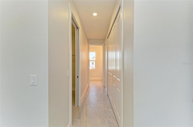 corridor with recessed lighting and baseboards