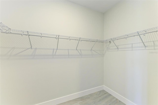 spacious closet with light wood-style flooring