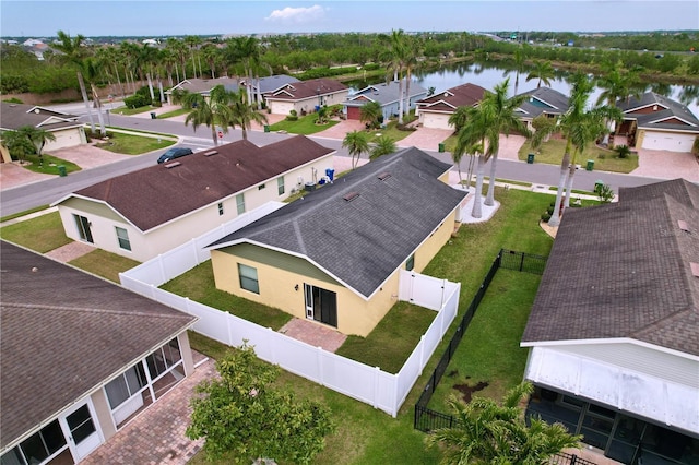 birds eye view of property with a residential view and a water view