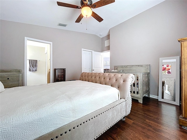bedroom featuring ceiling fan, visible vents, wood finished floors, and vaulted ceiling