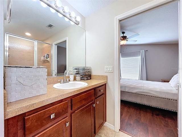 bathroom featuring visible vents, vanity, ensuite bathroom, ceiling fan, and a stall shower