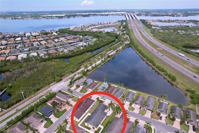 birds eye view of property featuring a residential view and a water view