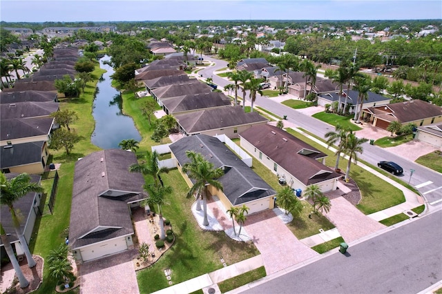 birds eye view of property featuring a water view and a residential view