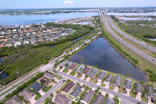 birds eye view of property with a residential view and a water view