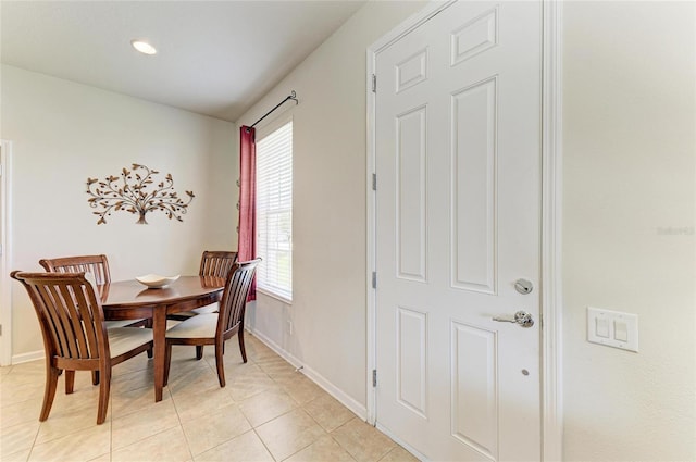 dining room featuring baseboards and light tile patterned flooring
