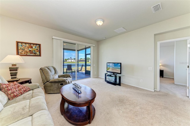 carpeted living room featuring visible vents and baseboards