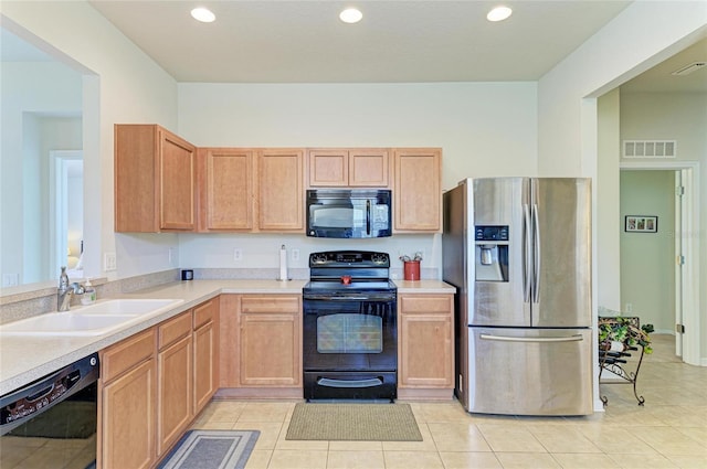 kitchen with recessed lighting, light tile patterned floors, light countertops, black appliances, and a sink