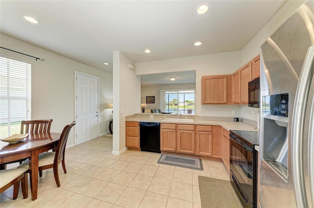 kitchen featuring black appliances, recessed lighting, a sink, and light countertops