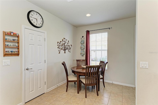 dining area with light tile patterned floors and baseboards