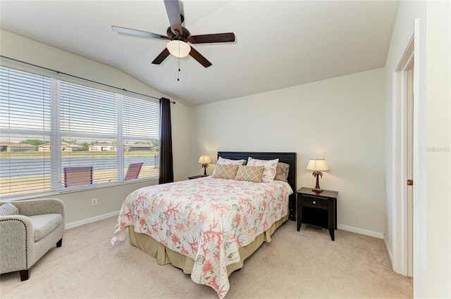 bedroom featuring baseboards, a ceiling fan, light carpet, and lofted ceiling