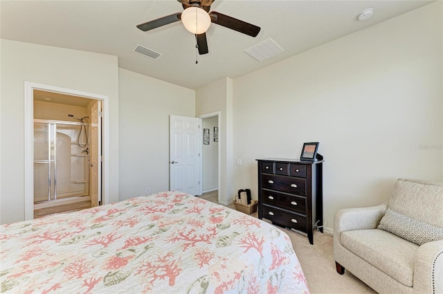 bedroom with light colored carpet, visible vents, ensuite bathroom, and a ceiling fan