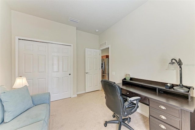 office space with baseboards, visible vents, and light colored carpet