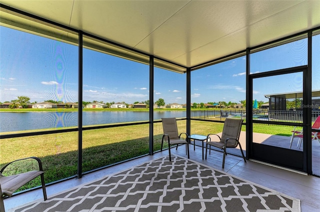 unfurnished sunroom featuring a water view