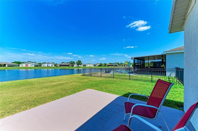 view of patio / terrace with a water view and fence