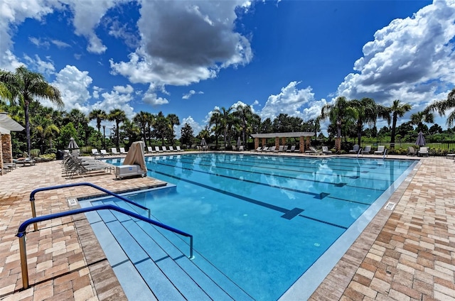 pool featuring fence and a patio