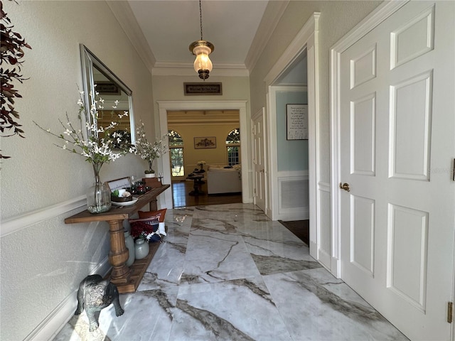 708 E Main St, Wauchula, FL 33873 - corridor featuring marble finish floor, ornamental molding, a wainscoted wall, and a textured wall