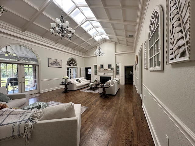 708 E Main St, Wauchula, FL 33873 - living room with french doors, dark wood finished floors, a fireplace, a chandelier, and baseboards