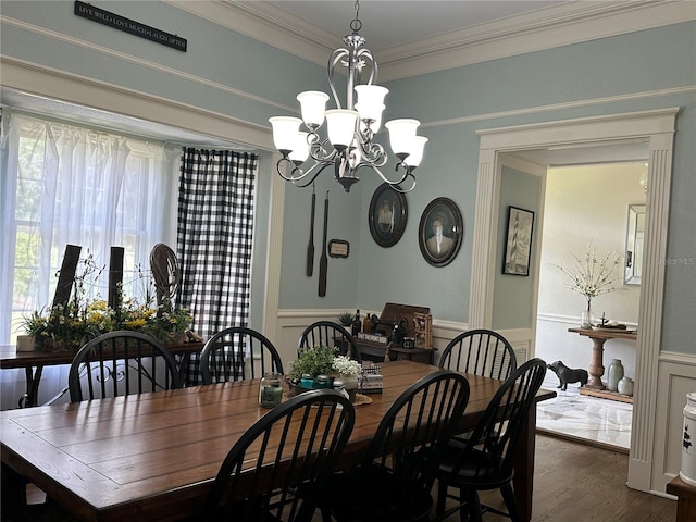 708 E Main St, Wauchula, FL 33873 - dining area featuring wainscoting, crown molding, a notable chandelier, and wood finished floors